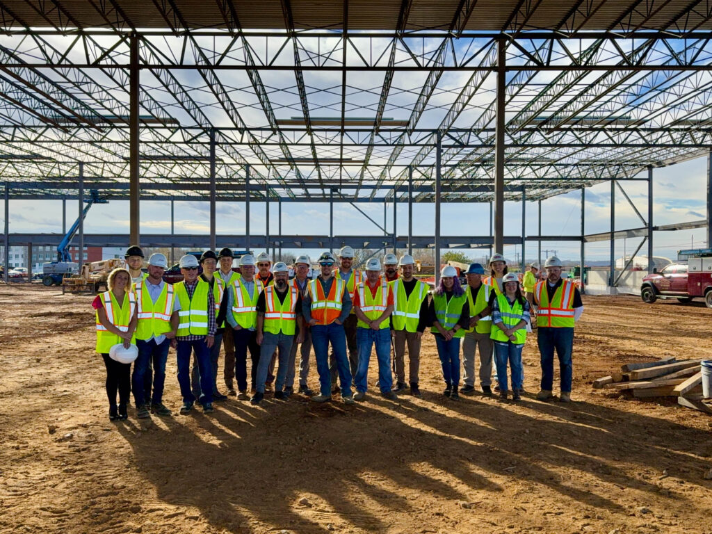 Large project team portrait at active construction site